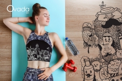 Slim fitness model is exercising on the floor on a yoga mat